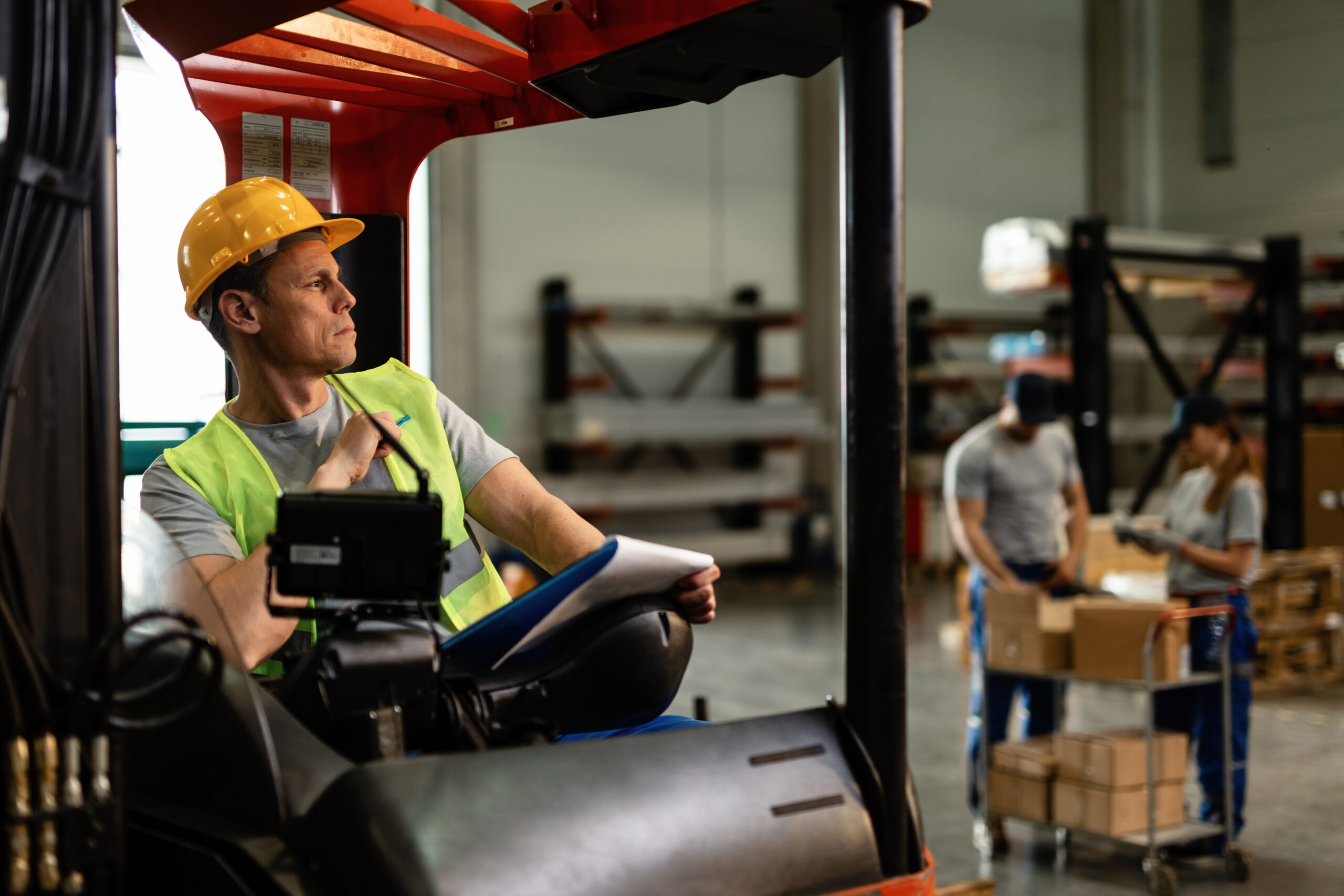 Pensive forklift driver in a distribution warehouse